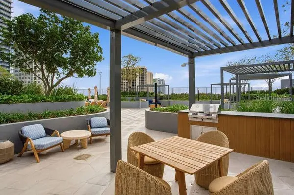 a view of a patio with couches chairs and a fire pit
