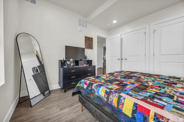 2101 North Main Street, Unit 409 Sunset, UT 84015 - Photo 14 of 18 Bedroom featuring wood finished floors, a closet, and recessed lighting
