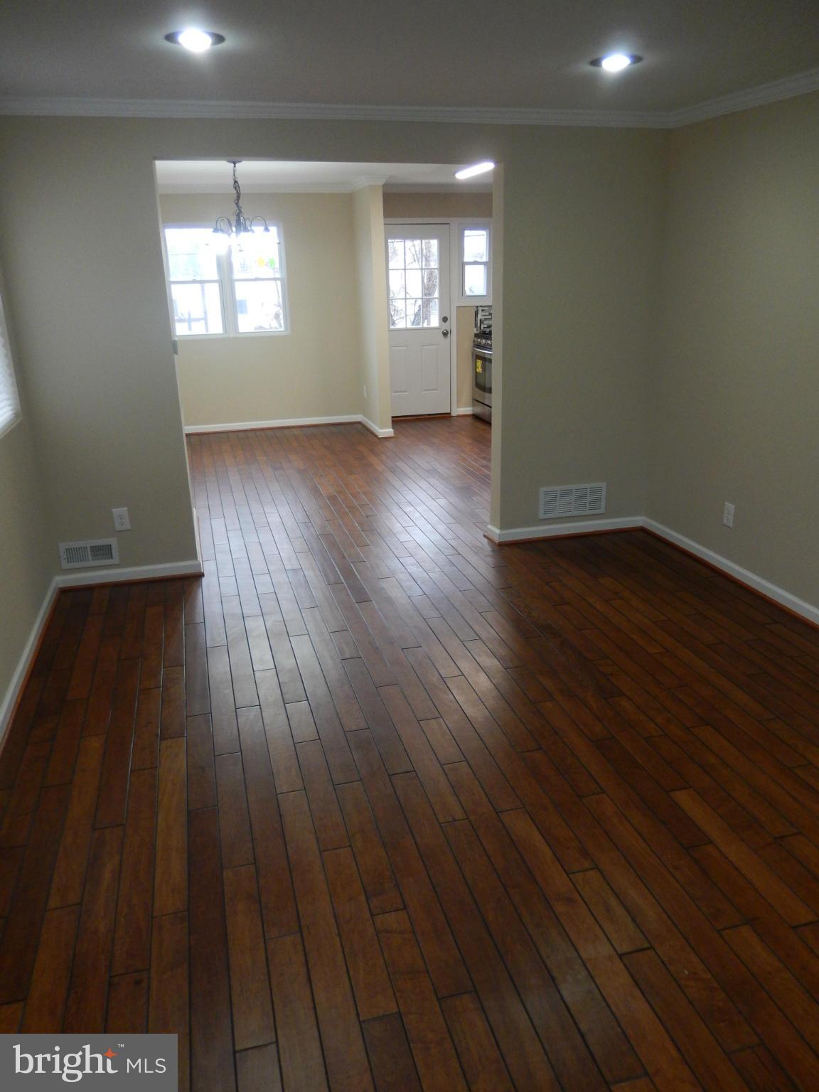 925 Coleridge Road Baltimore, MD 21229 - Photo 3 of 30 an empty room with wooden floor and windows