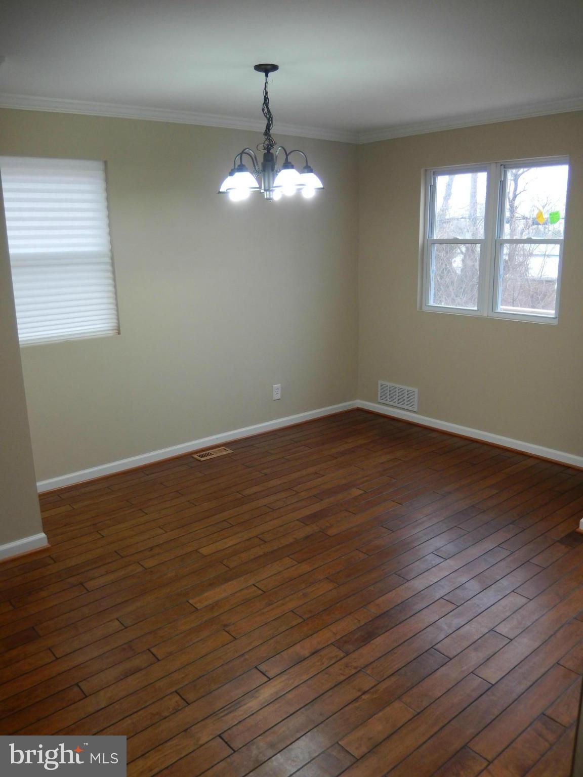 925 Coleridge Road Baltimore, MD 21229 - Photo 7 of 30 a view of wooden floor chandelier and window in a room