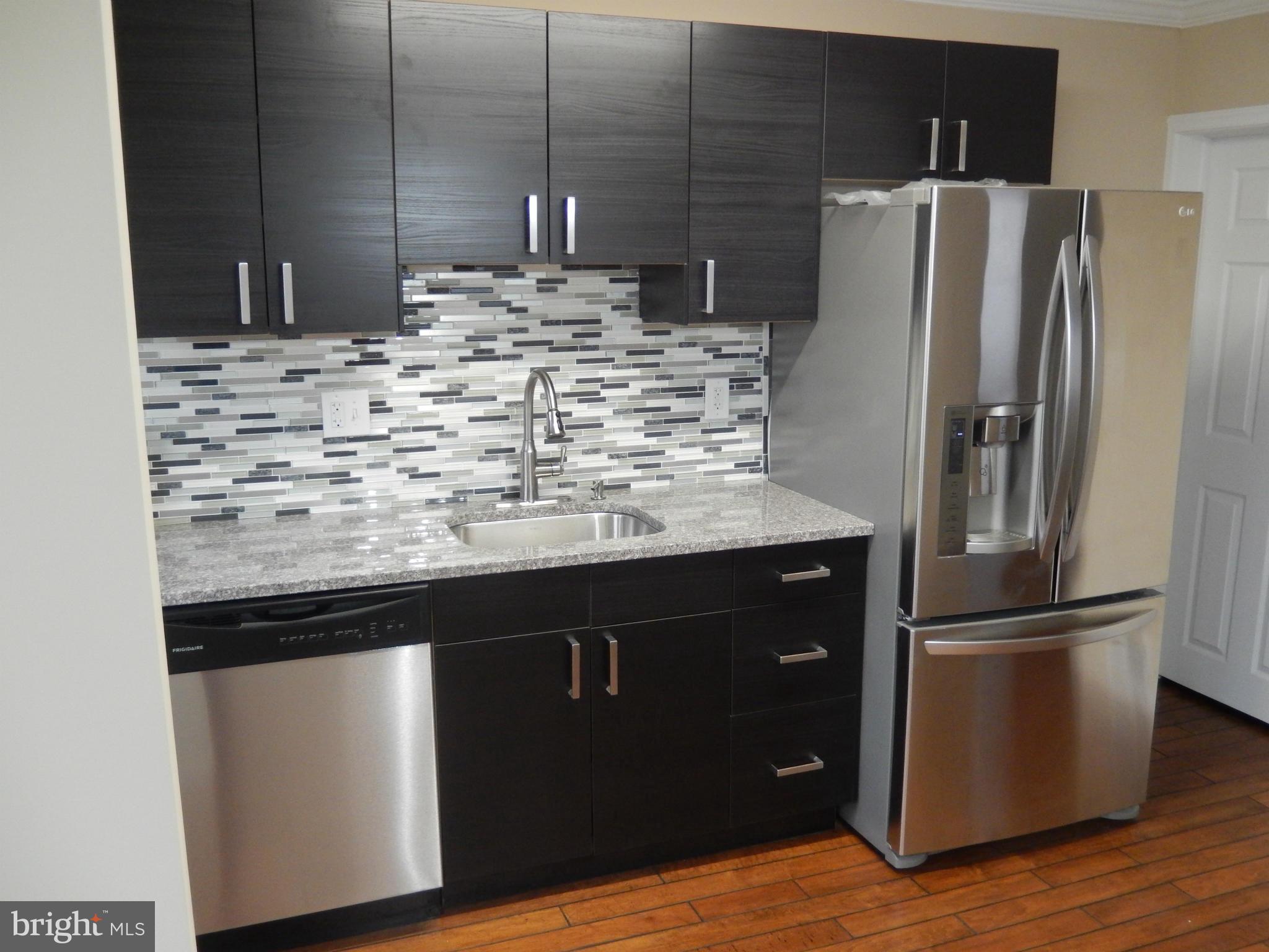 925 Coleridge Road Baltimore, MD 21229 - Photo 8 of 30 a kitchen with granite countertop a refrigerator and a sink