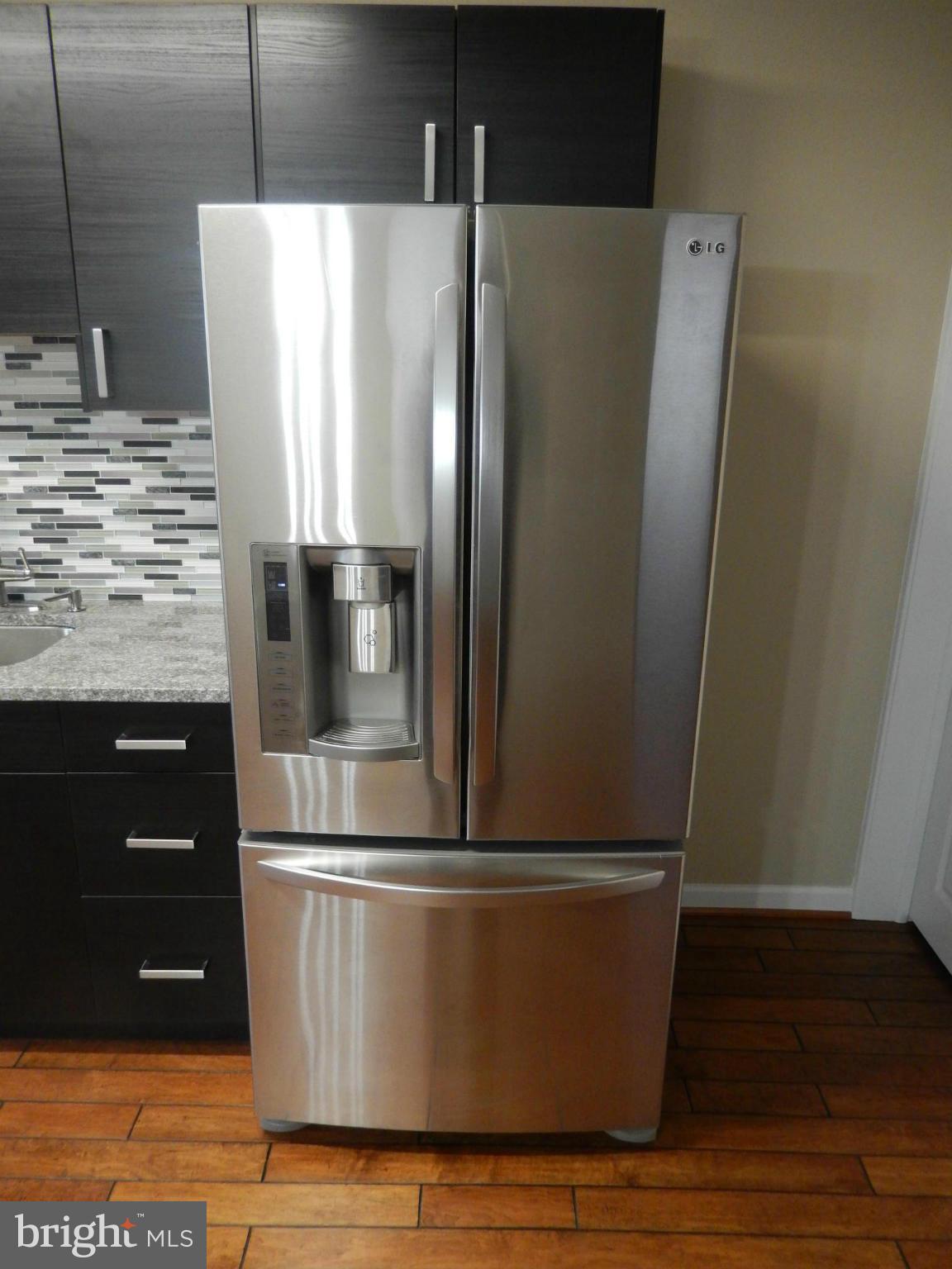 925 Coleridge Road Baltimore, MD 21229 - Photo 9 of 30 a view of a refrigerator with wooden floor