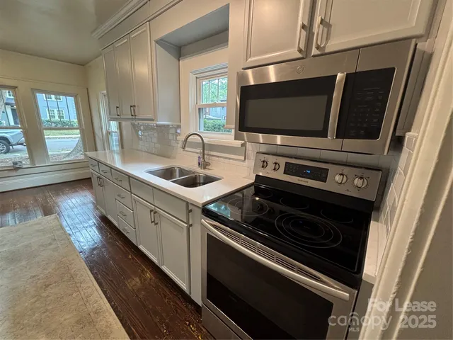a kitchen with a stove and a microwave