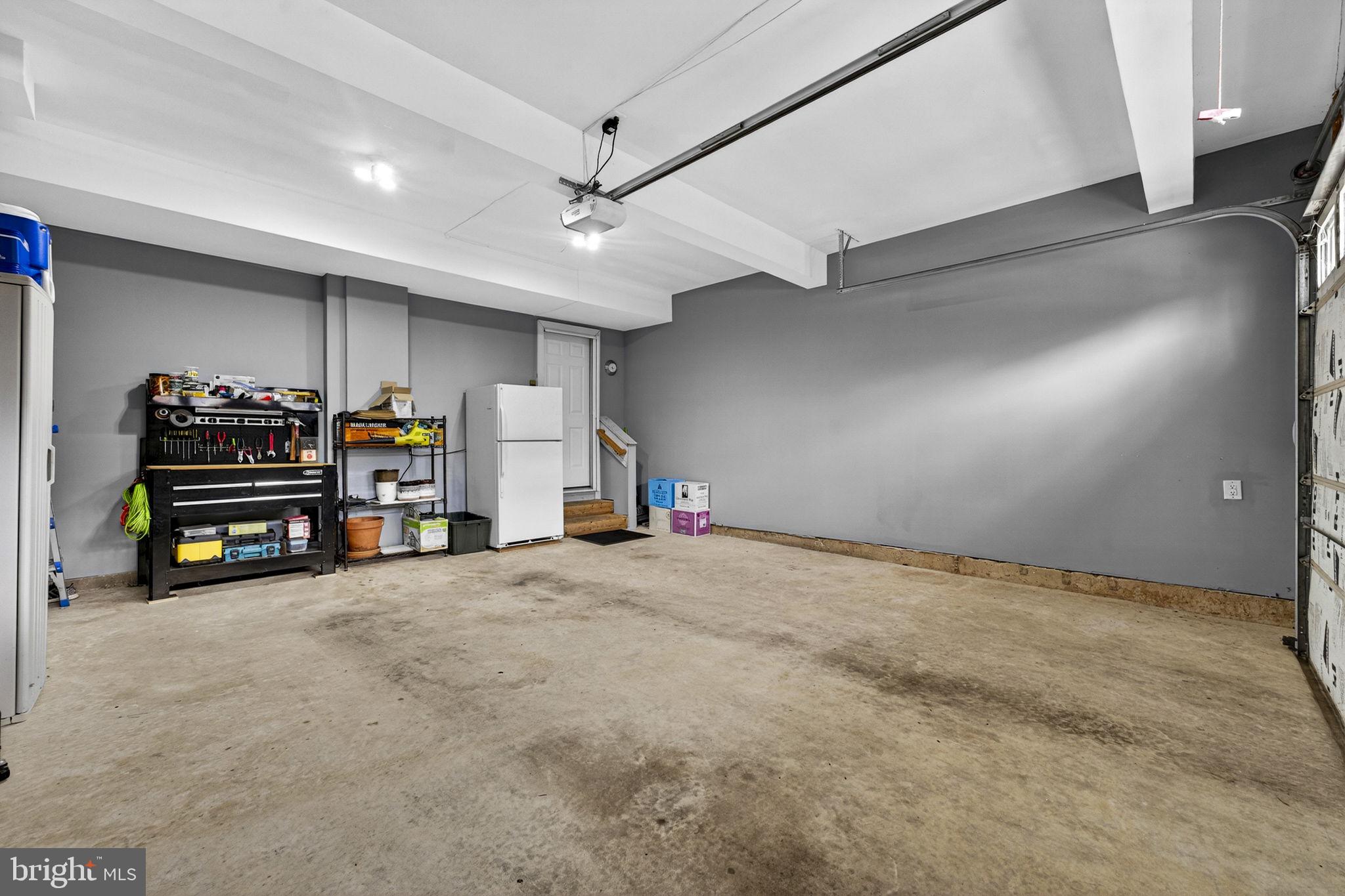 6913 Bitterroot Court Gainesville, VA 20155 - Photo 43 of 56 Paint like primer in garage- workbench conveys