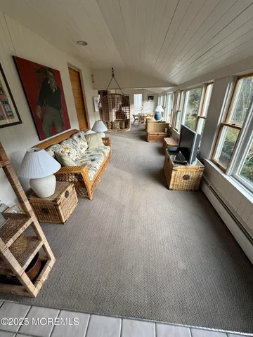 a living room with furniture a fireplace and a large window