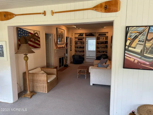 a bed sitting in a bedroom next to a book shelf