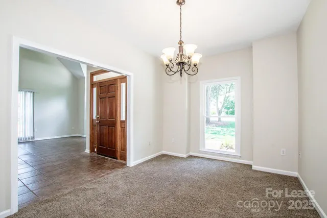 a view of a chandelier in big room and chandelier