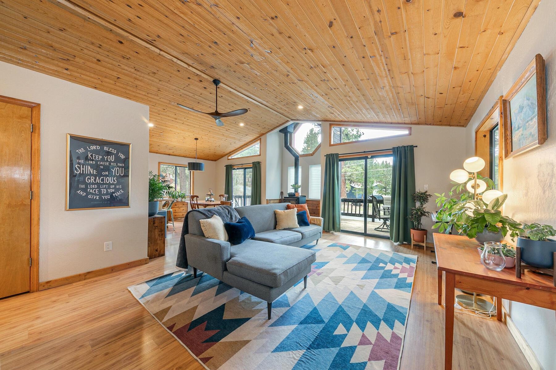 a living room with furniture a dining table and a large window