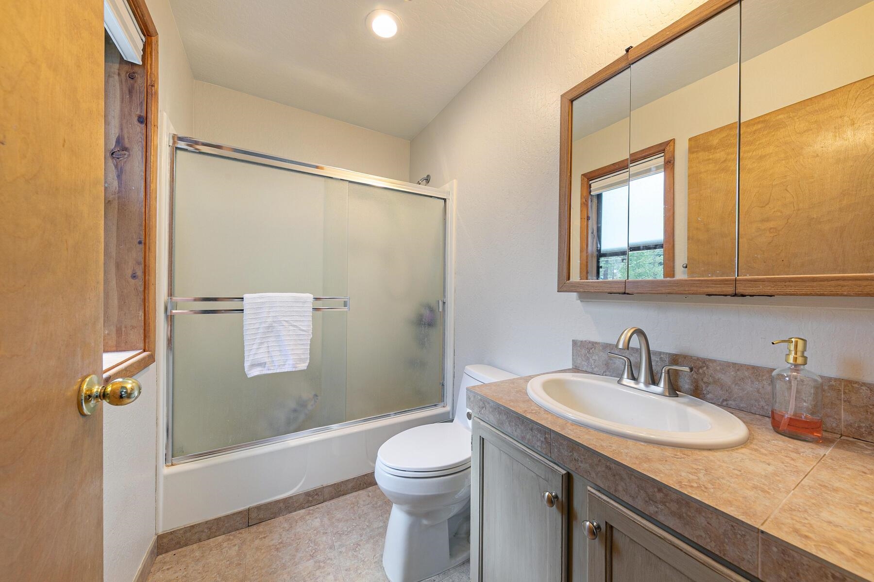 10455 Regency Circle Truckee, CA 96161 - Photo 14 of 28 a bathroom with a granite countertop sink toilet and shower