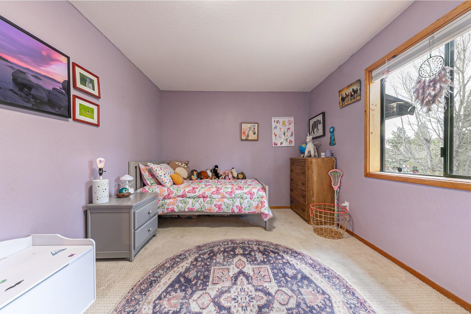 10455 Regency Circle Truckee, CA 96161 - Photo 15 of 28 a bedroom with a bed and wooden floor