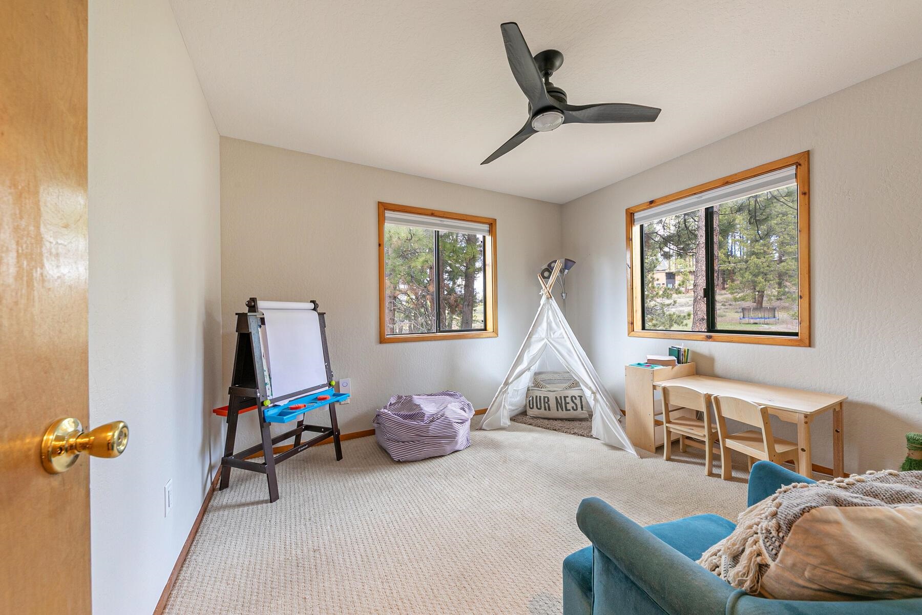 10455 Regency Circle Truckee, CA 96161 - Photo 18 of 28 a living room with furniture a ceiling fan and a window