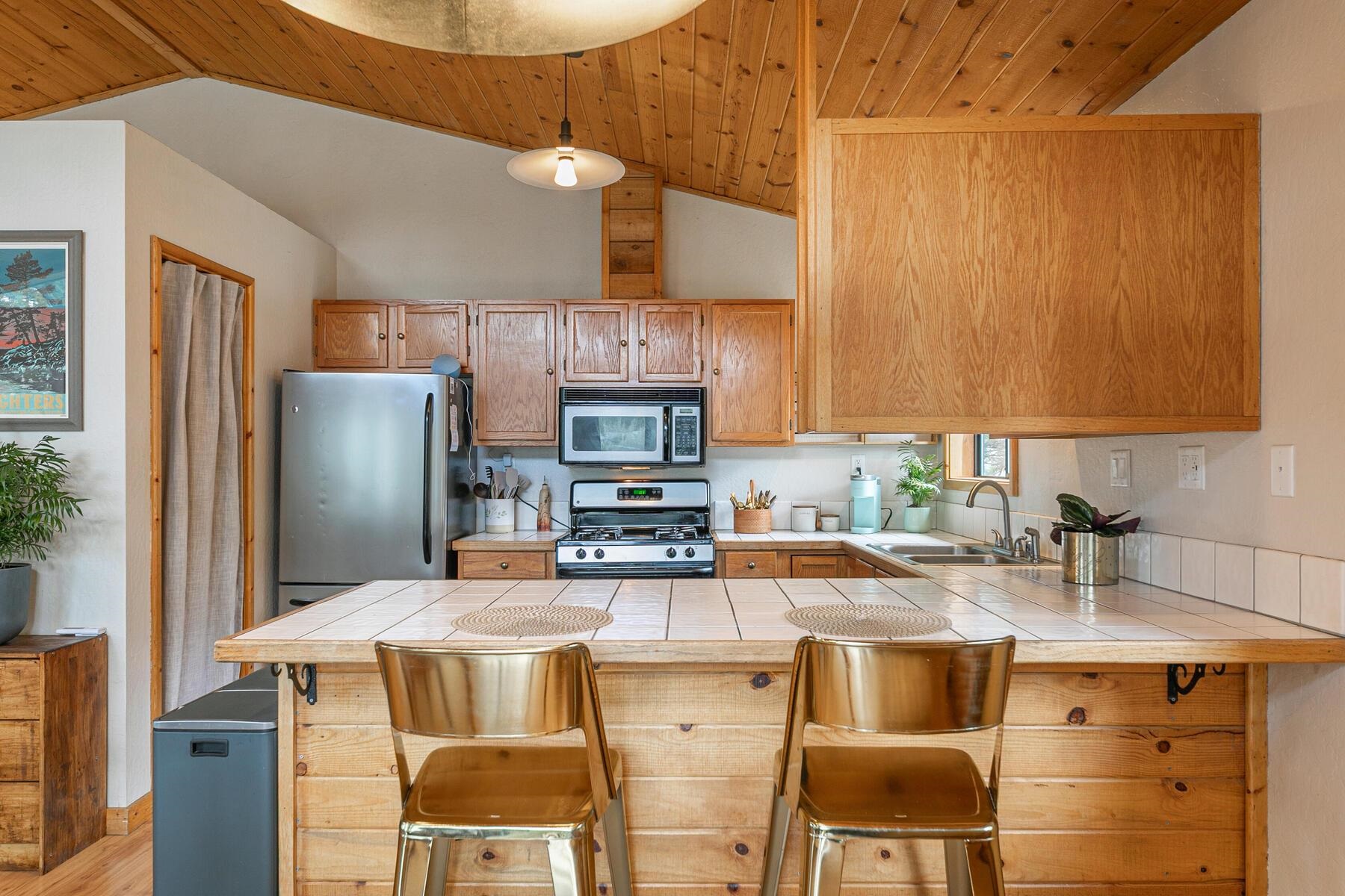 10455 Regency Circle Truckee, CA 96161 - Photo 9 of 28 a kitchen with stainless steel appliances granite countertop a sink a stove and a refrigerator