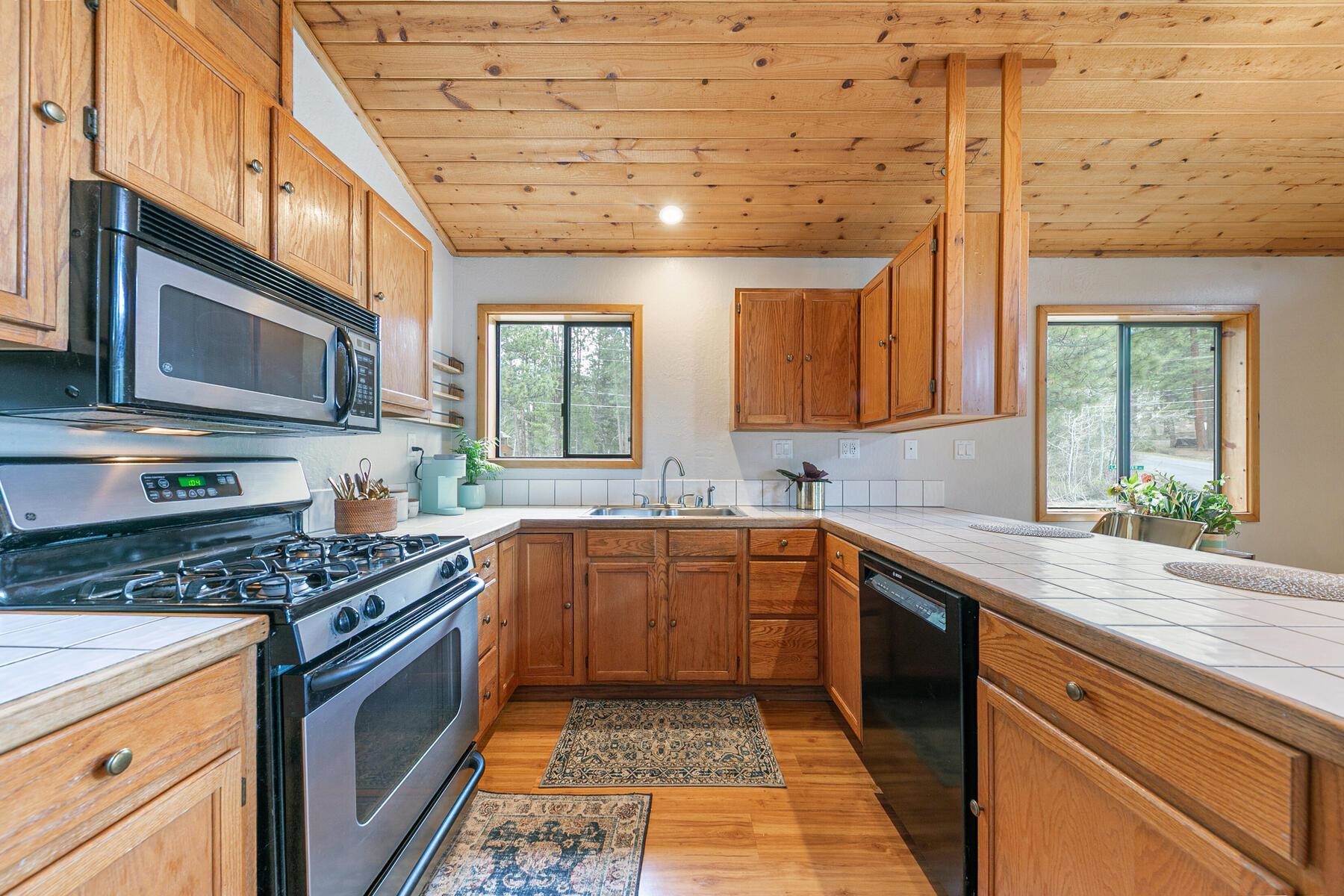 10455 Regency Circle Truckee, CA 96161 - Photo 10 of 28 a kitchen with stainless steel appliances granite countertop a stove a sink and a microwave