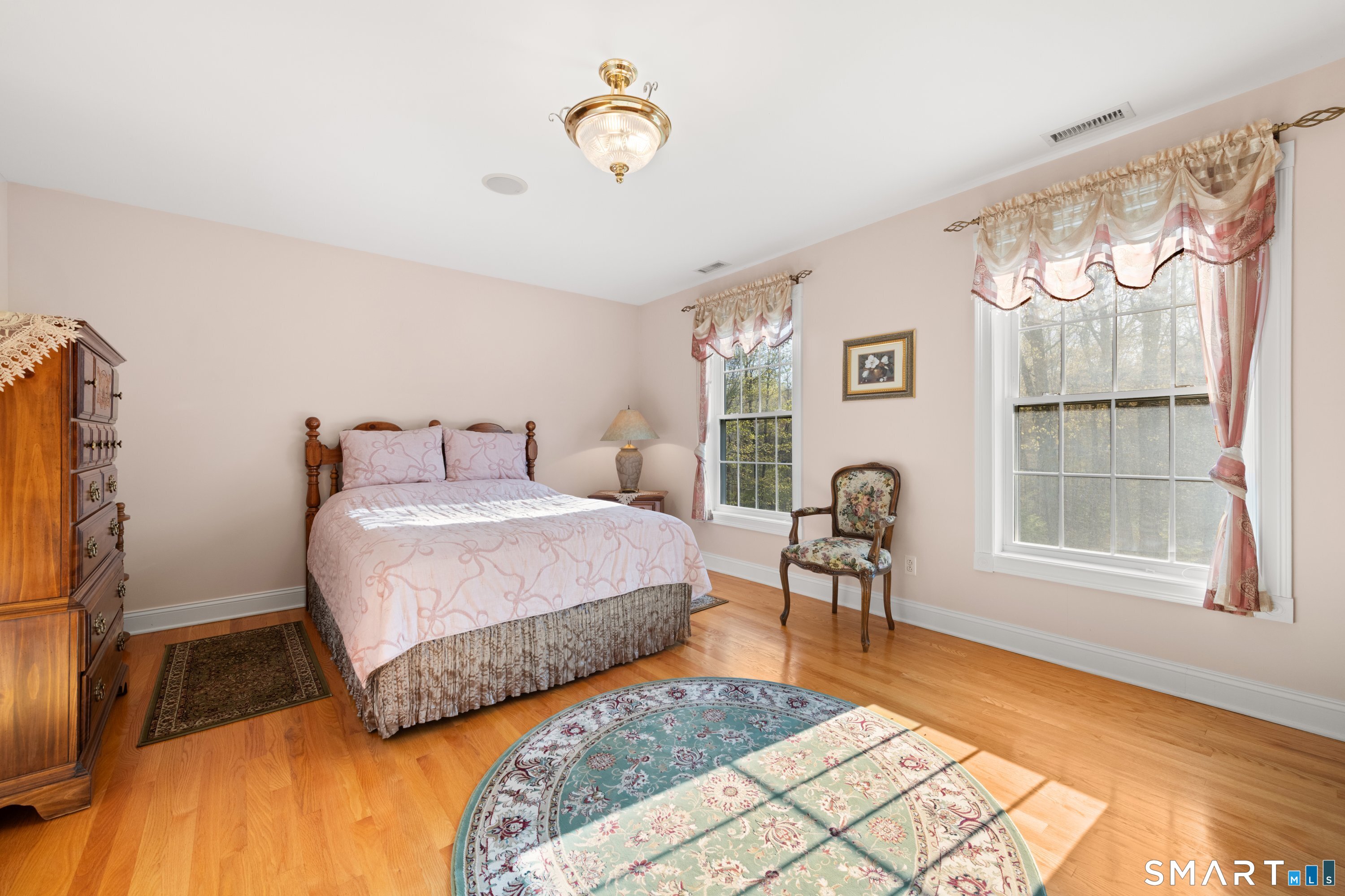 420 Summer Hill Road Madison, CT 06443 - Photo 27 of 40 a bedroom with a bed and a table with chair