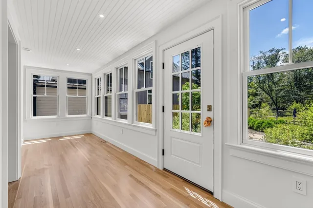a view of wooden floor and windows in a room