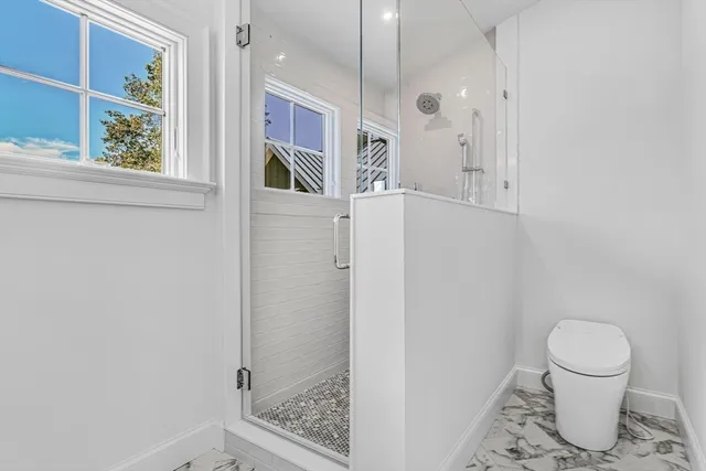 a bathroom with a window and a shower