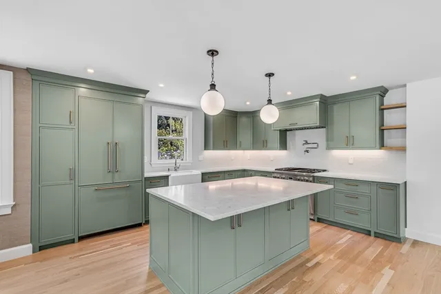 a kitchen with cabinets and wooden floor
