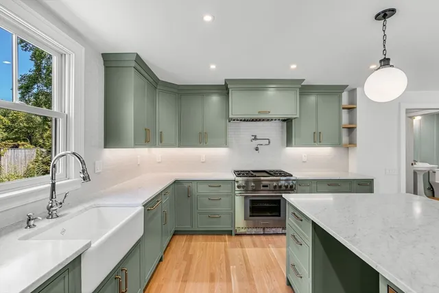 a kitchen with a sink stove and cabinets