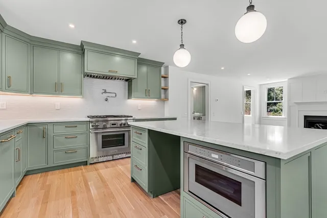 a kitchen with stainless steel appliances granite countertop a stove and a sink