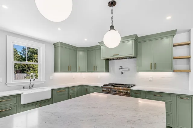 a bathroom with a tub a sink and a large mirror