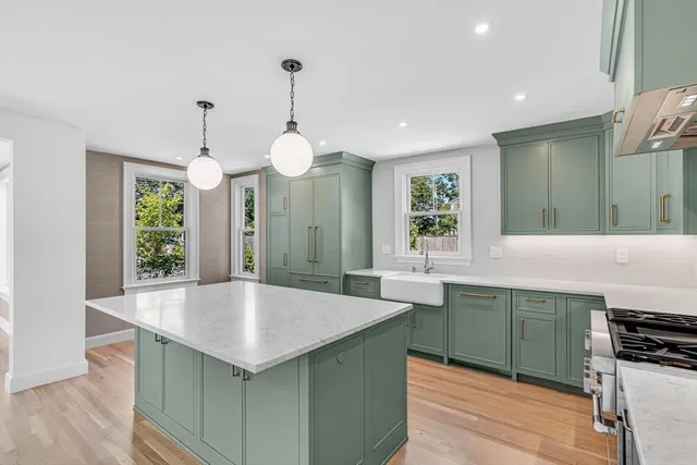 a kitchen with counter top space cabinets and wooden floor