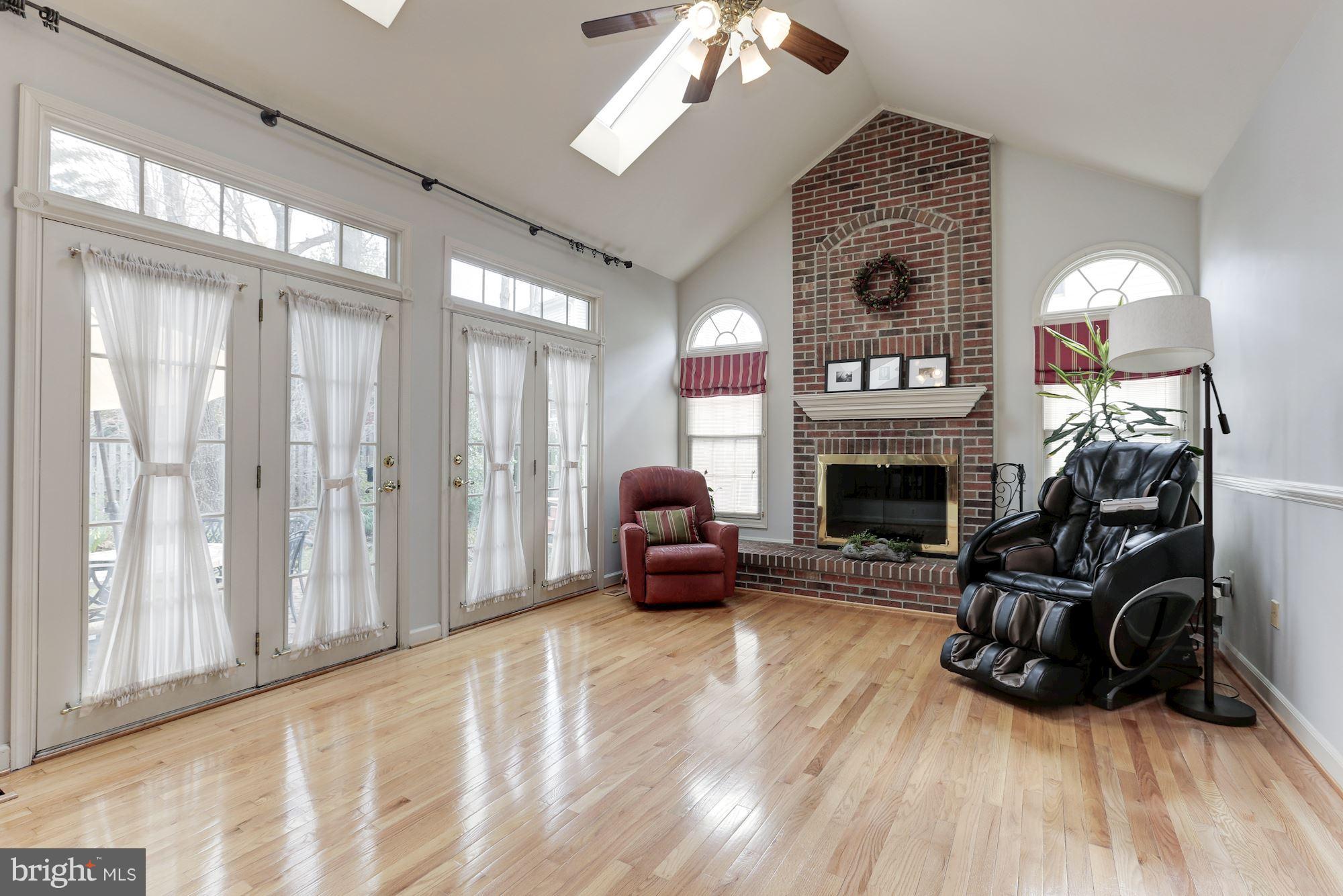6402 Springhouse Circle Clifton, VA 20124 - Photo 14 of 30 a living room with furniture a fireplace and a flat screen tv
