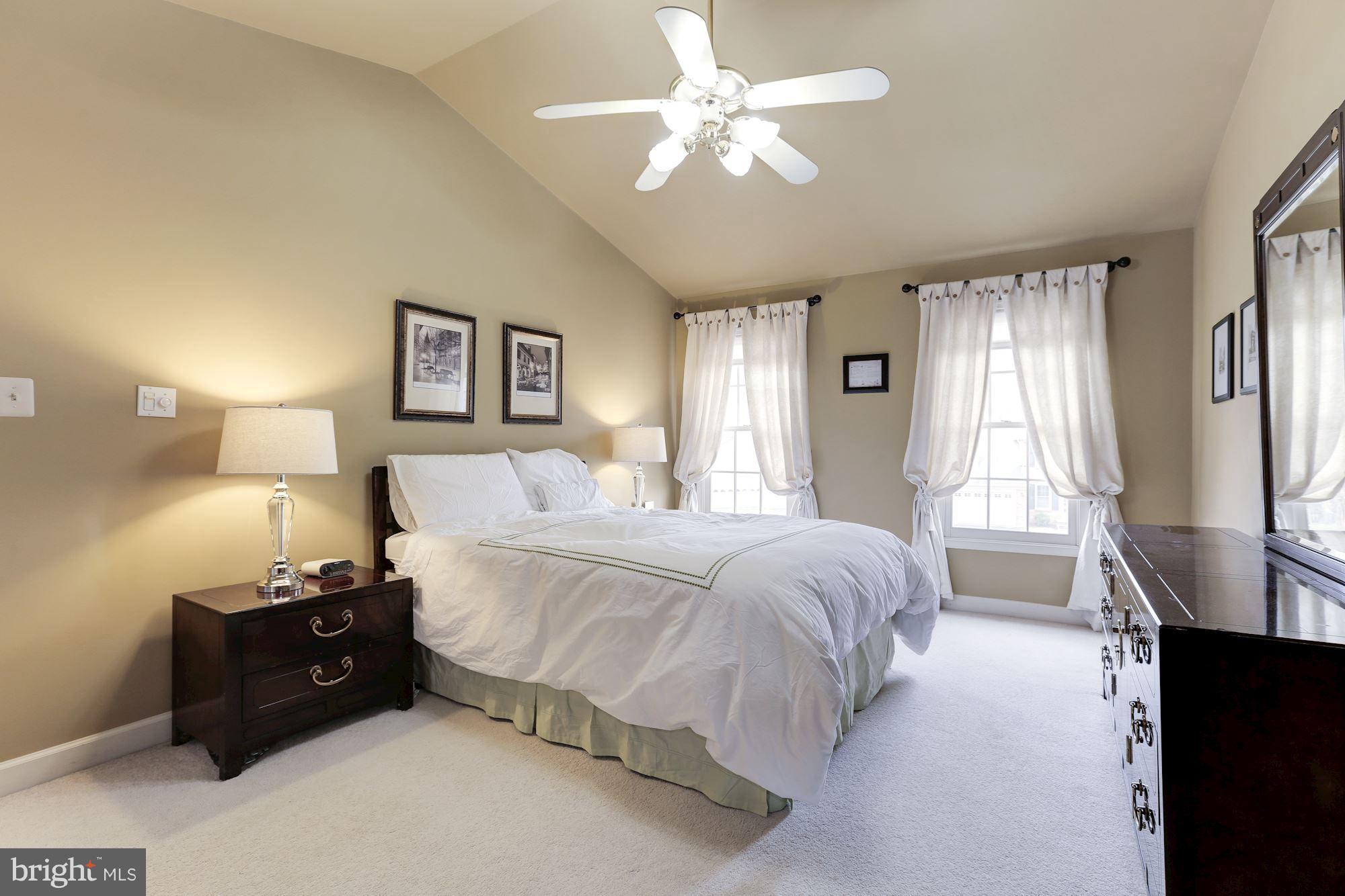 6402 Springhouse Circle Clifton, VA 20124 - Photo 17 of 30 a spacious bedroom with a bed and a chandelier