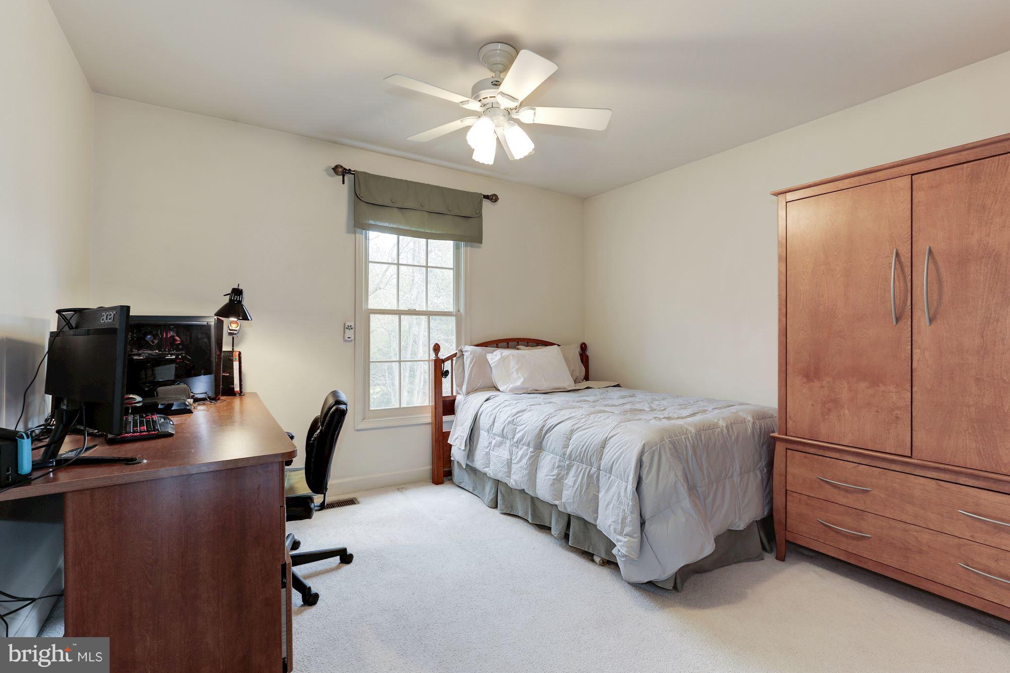 6402 Springhouse Circle Clifton, VA 20124 - Photo 26 of 30 a bedroom with a bed and a chandelier