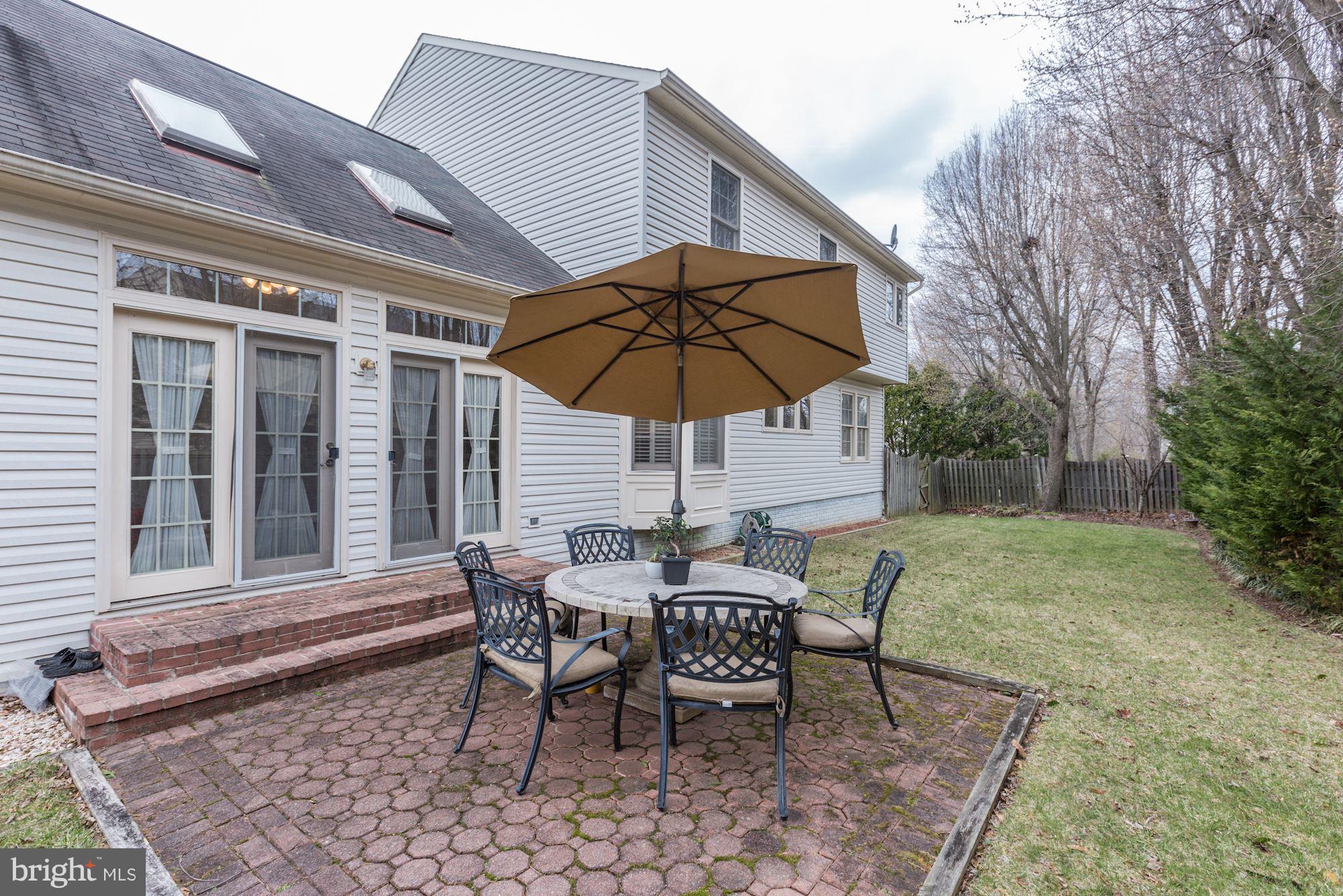 6402 Springhouse Circle Clifton, VA 20124 - Photo 30 of 30 a view of a backyard with table and chairs under an umbrella