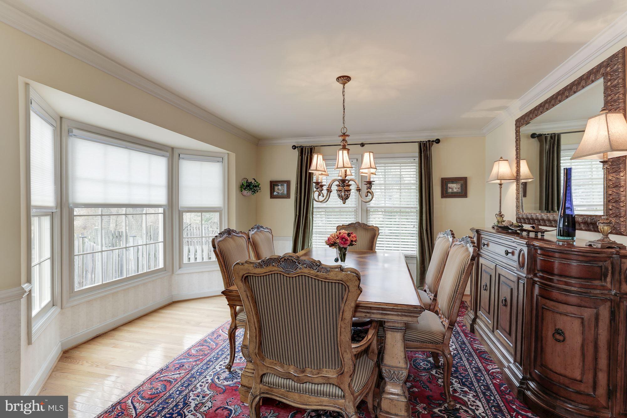 6402 Springhouse Circle Clifton, VA 20124 - Photo 8 of 30 a view of a dining room with furniture window and wooden floor