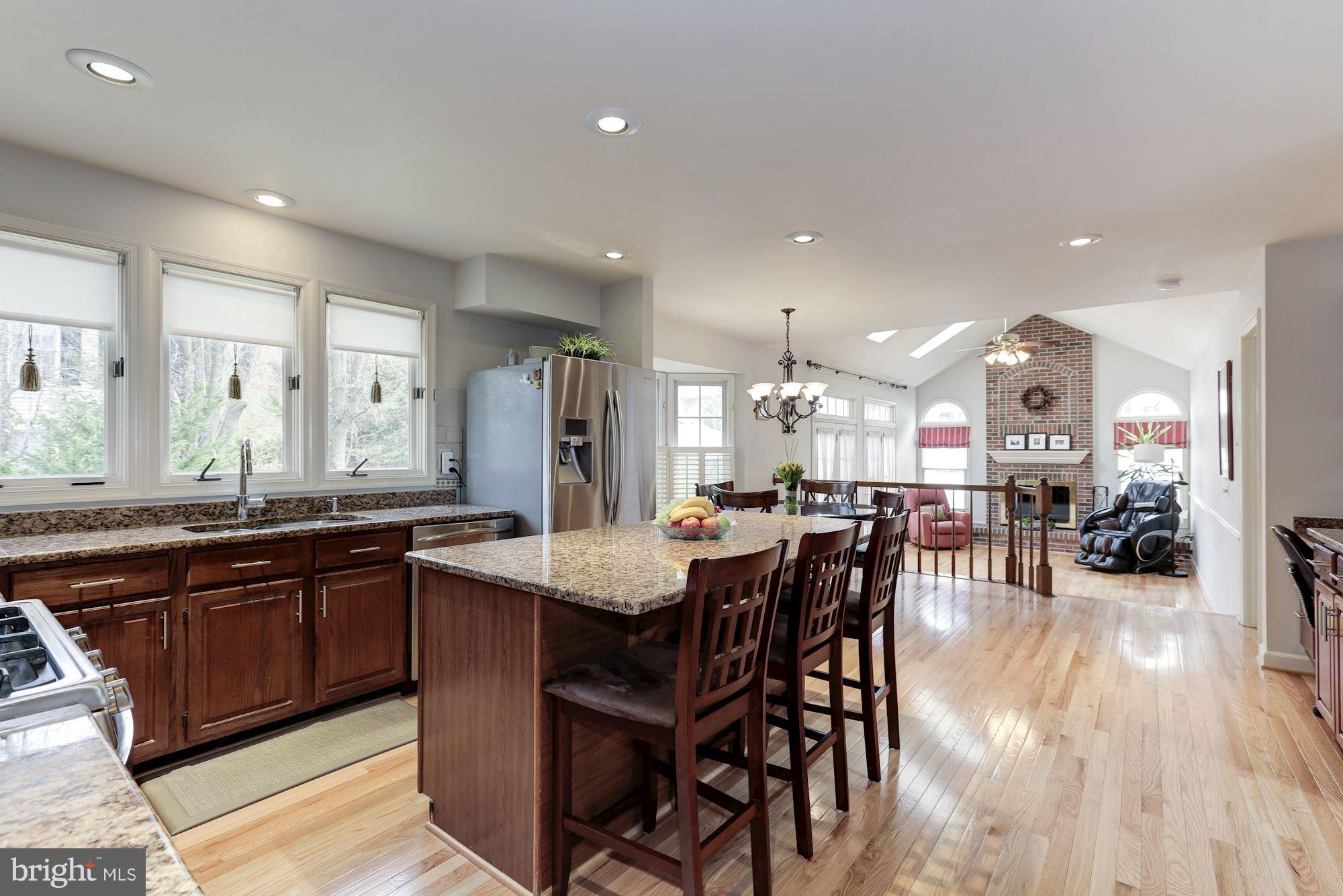 6402 Springhouse Circle Clifton, VA 20124 - Photo 10 of 30 a kitchen with lots of counter top space and painting on the wall