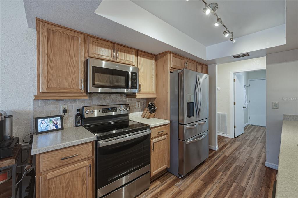 7435 Kilbride Court Weeki Wachee, FL 34613 - Photo 19 of 67 a kitchen with a refrigerator stove and microwave
