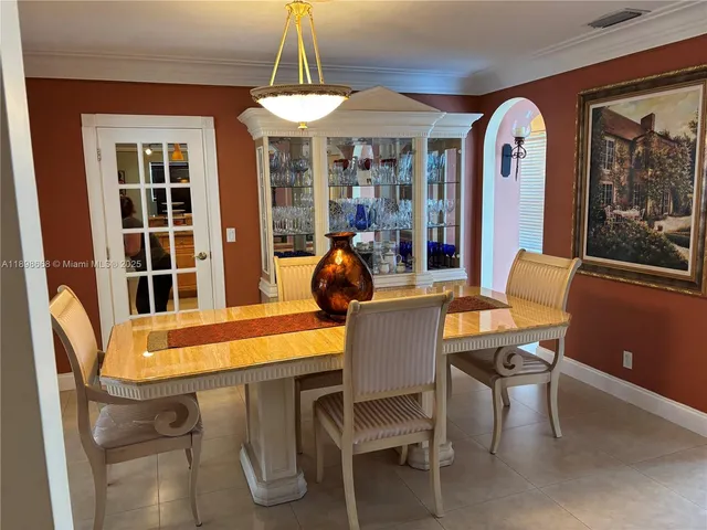 a dining room with furniture a chandelier and window