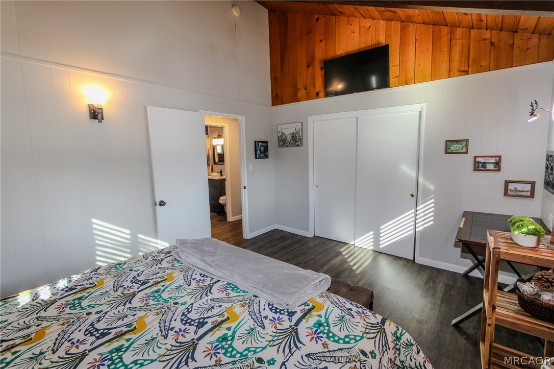 42830 Cougar Road, Unit UPPR Big Bear Lake, CA 92315 - Photo 10 of 21 a bedroom with a bed and a flat screen tv