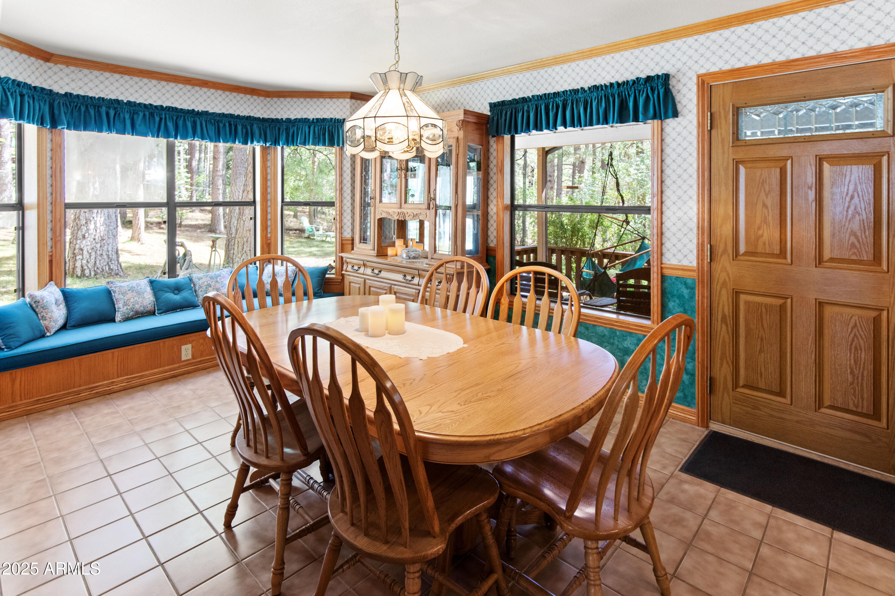 3910 Larson Loop Forest Lakes, AZ 85931 - Photo 15 of 57 a view of a dining room with furniture a chandelier and large windows