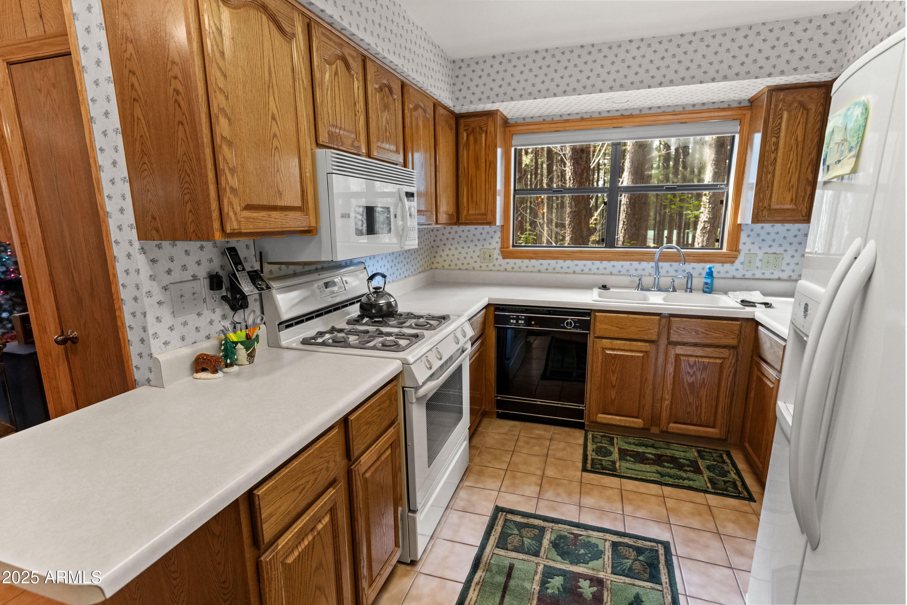 3910 Larson Loop Forest Lakes, AZ 85931 - Photo 24 of 57 a kitchen with stainless steel appliances a stove a sink and a refrigerator