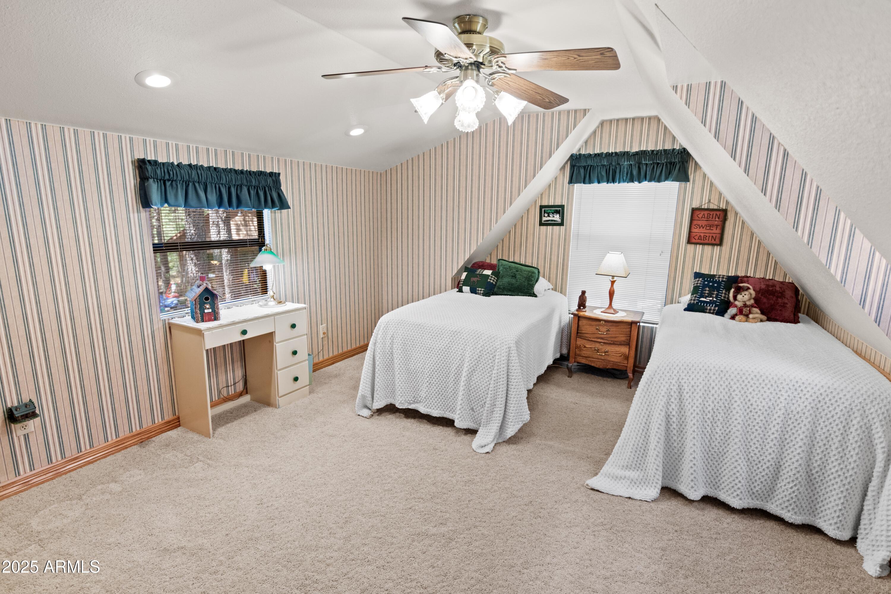 3910 Larson Loop Forest Lakes, AZ 85931 - Photo 40 of 57 a spacious bedroom with a bed and a walk in closet