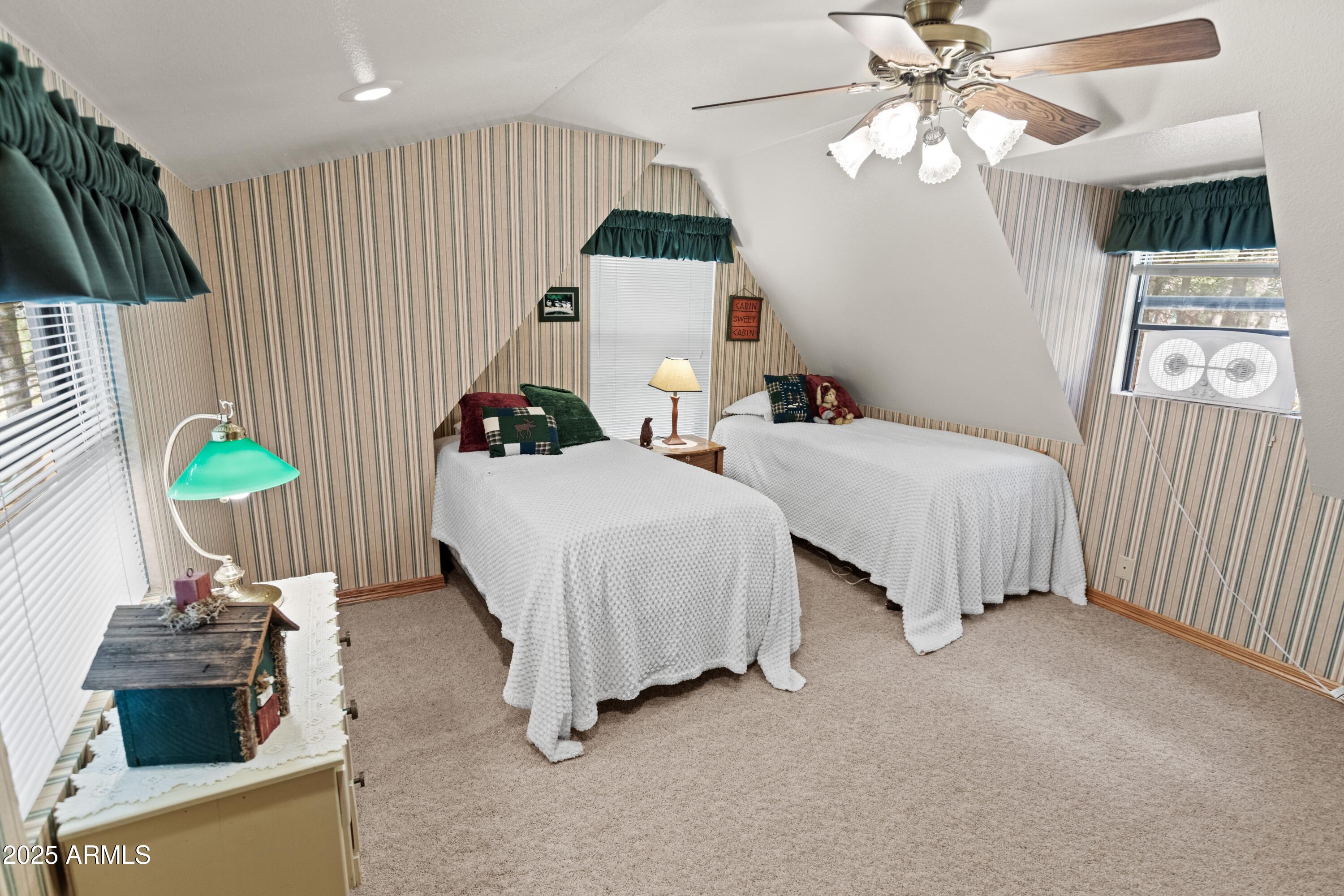 3910 Larson Loop Forest Lakes, AZ 85931 - Photo 41 of 57 a bedroom with bed a window and a chandelier