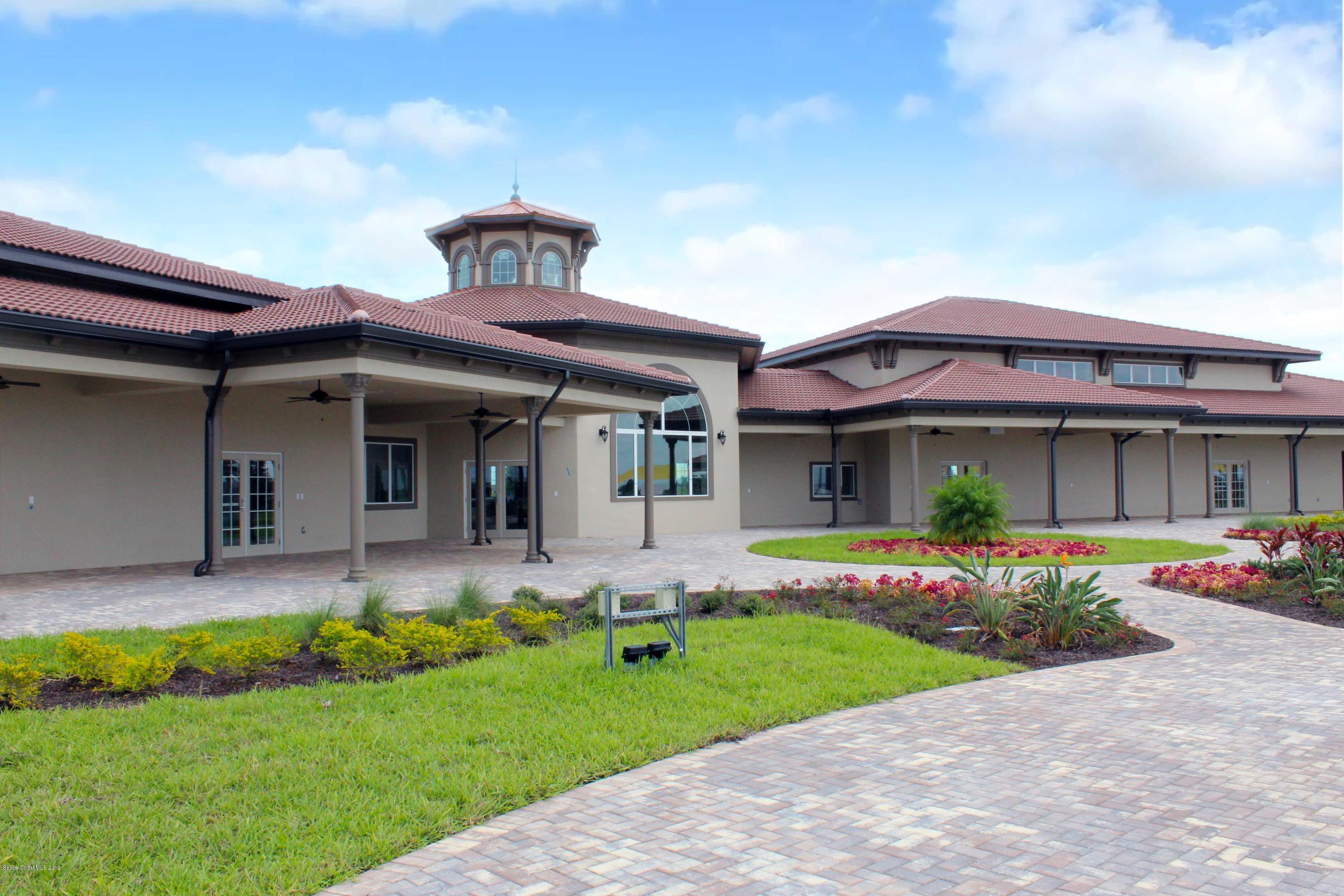 3094 Hummingbird Way Melbourne, FL 32940 - Photo 23 of 35 a front view of a house with a yard and porch