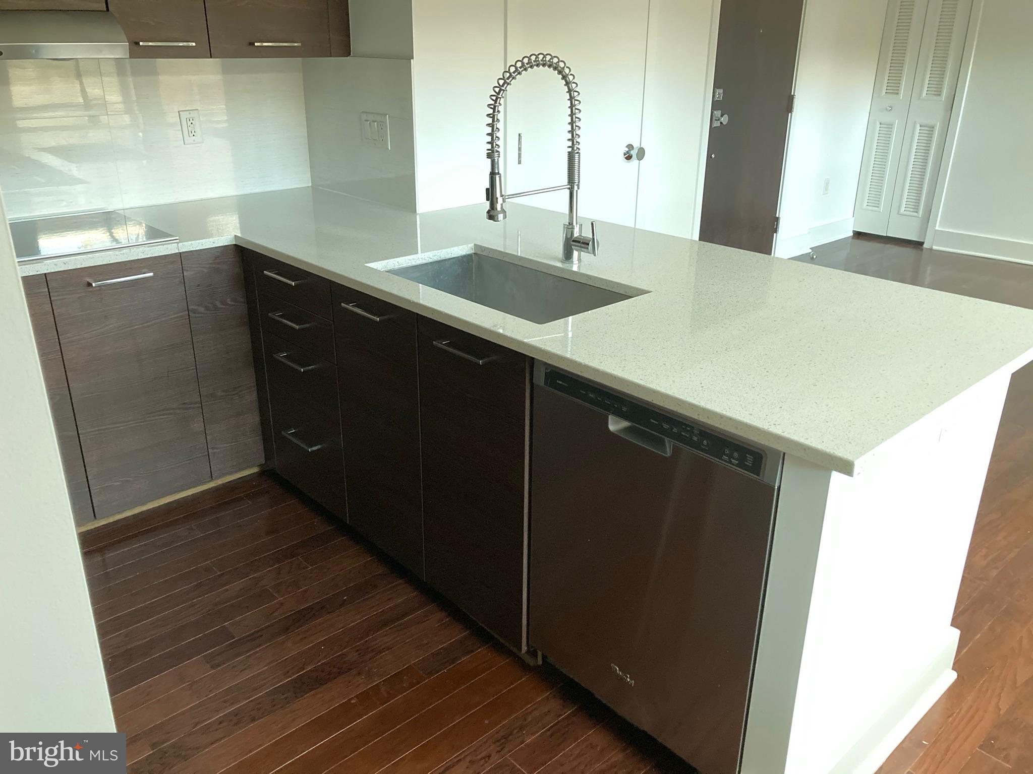 1020 Monroe Street Northwest, Unit 204 Washington, DC 20010 - Photo 5 of 30 a kitchen with a sink and a mirror