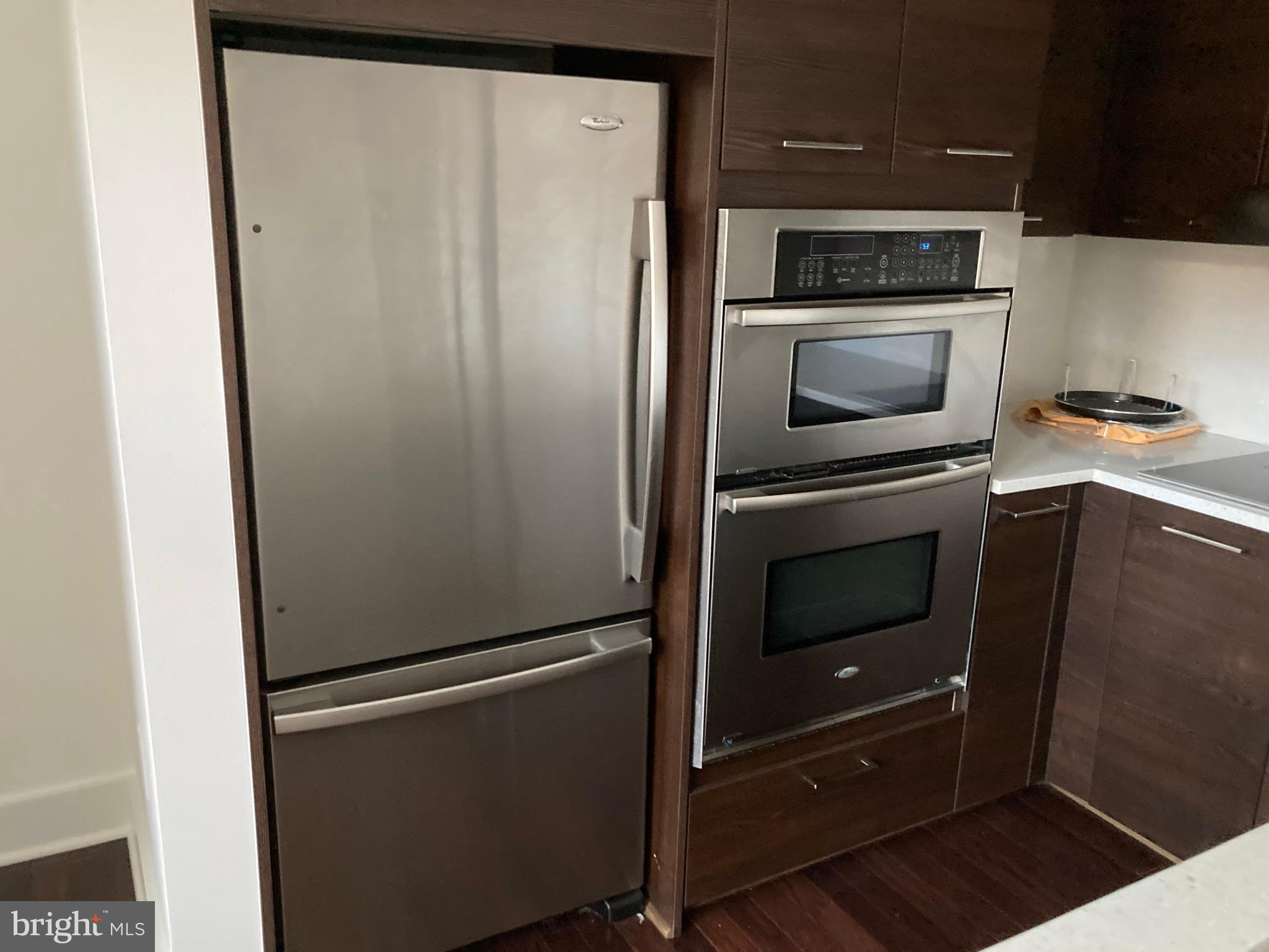 1020 Monroe Street Northwest, Unit 204 Washington, DC 20010 - Photo 6 of 30 a metallic refrigerator freezer sitting in a kitchen