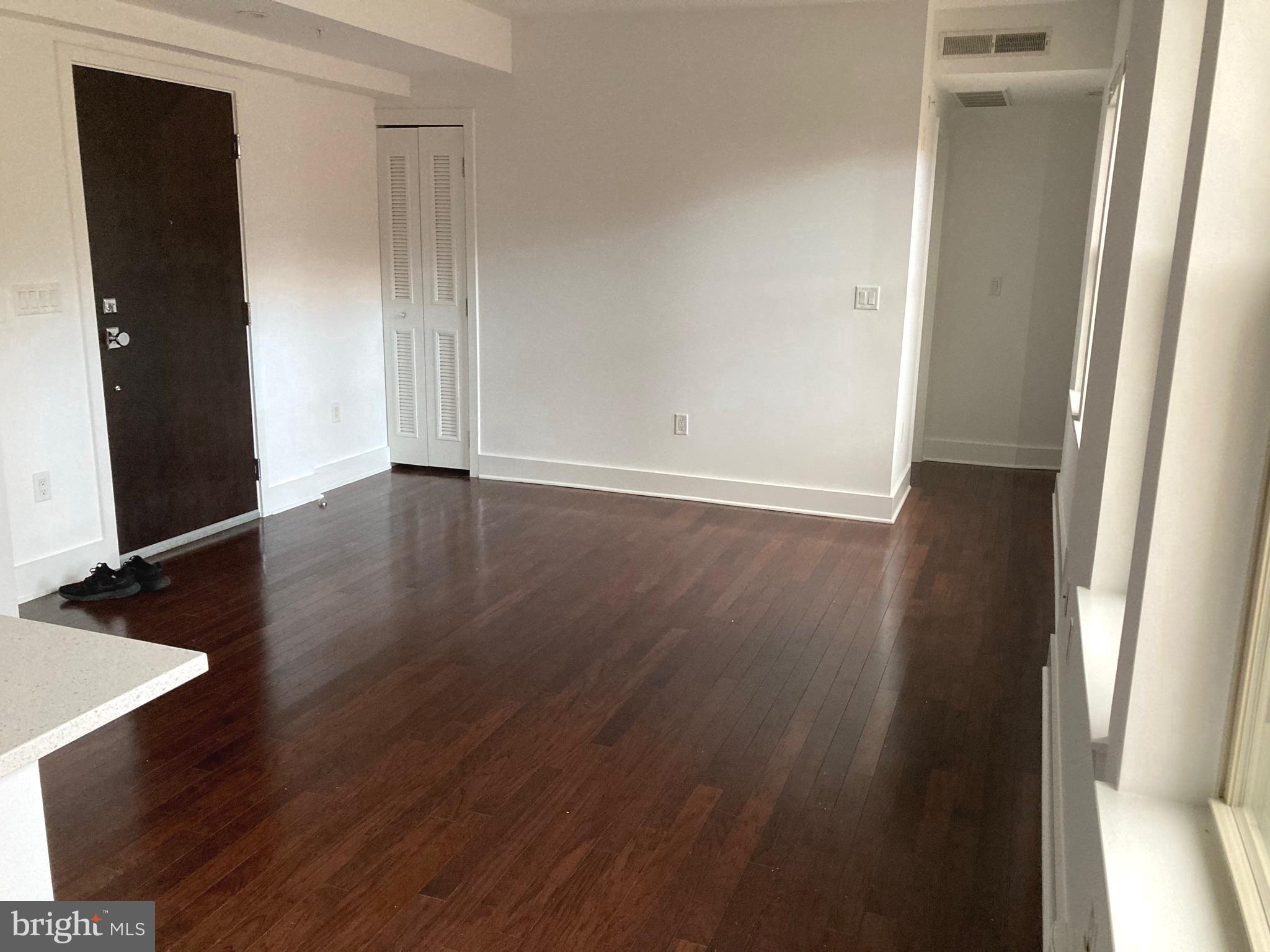 1020 Monroe Street Northwest, Unit 204 Washington, DC 20010 - Photo 7 of 30 a view of an empty room with wooden floor