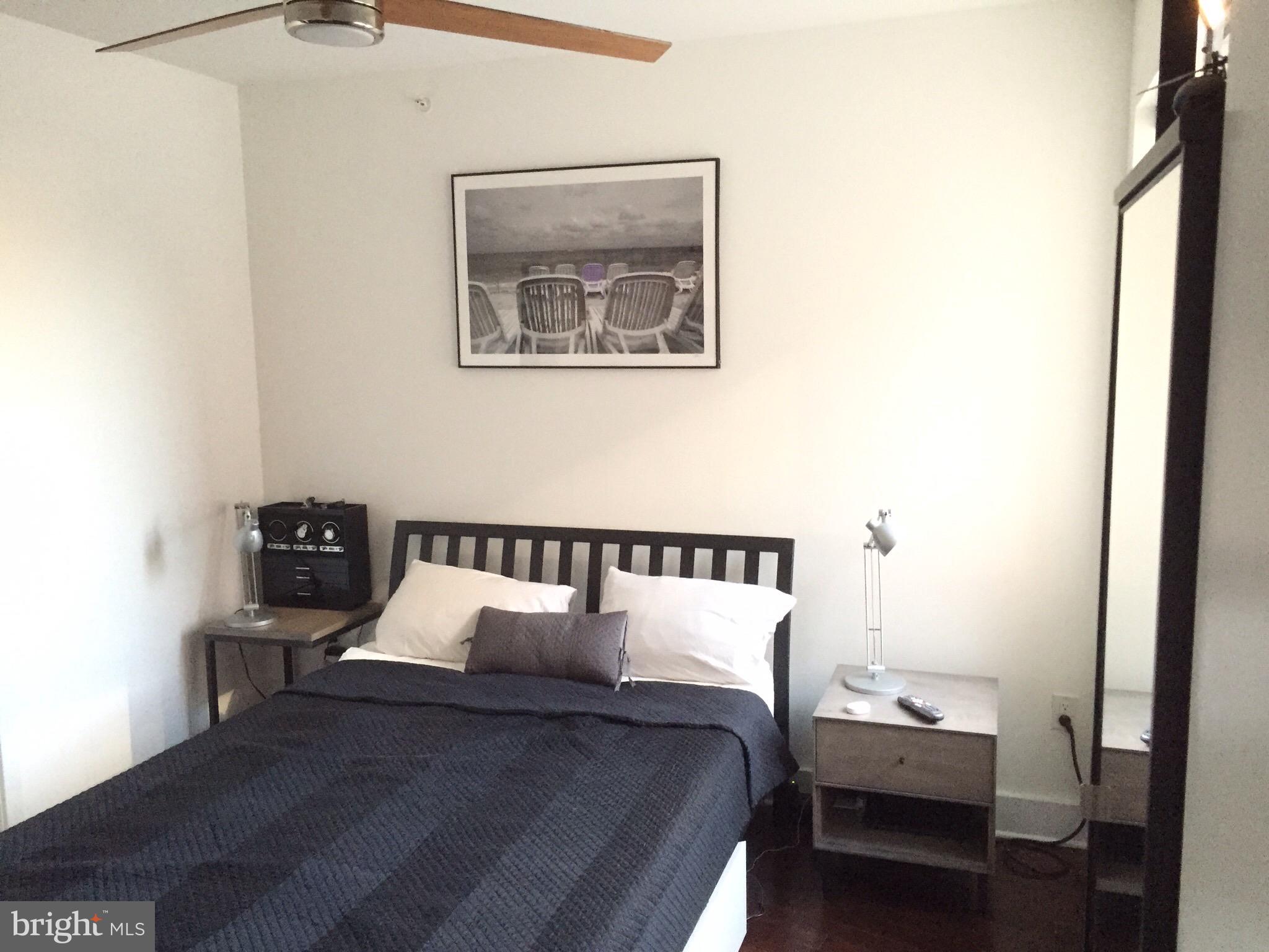 1020 Monroe Street Northwest, Unit 204 Washington, DC 20010 - Photo 8 of 30 a bed room with a bed and a tv