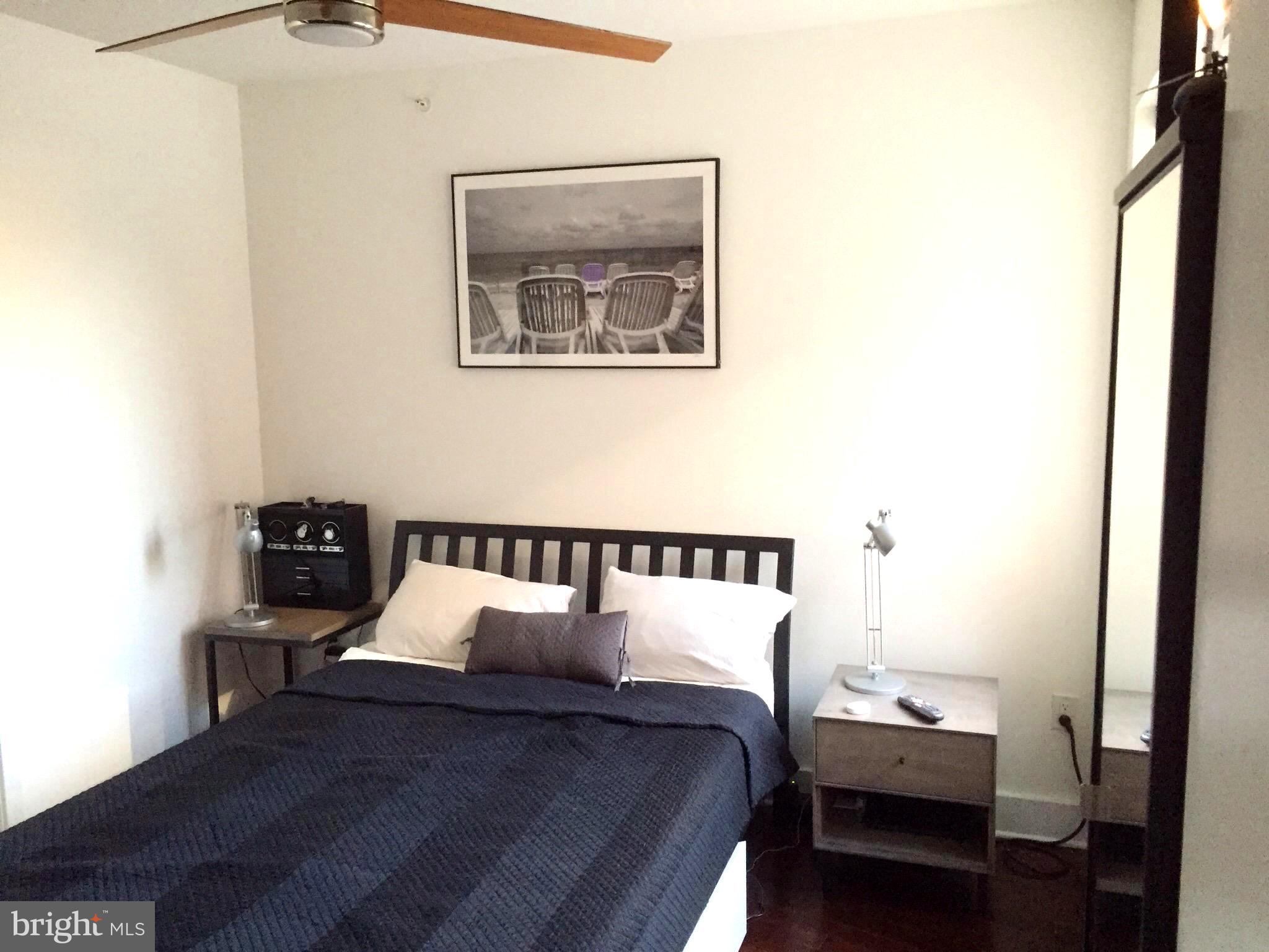 1020 Monroe Street Northwest, Unit 204 Washington, DC 20010 - Photo 8 of 29 a bed room with a bed and a tv
