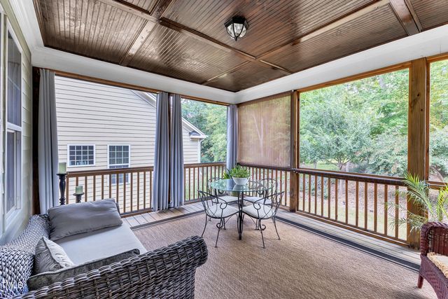 a balcony with furniture and wooden floor