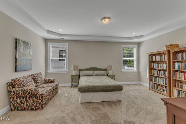 a bedroom with furniture and a book shelf