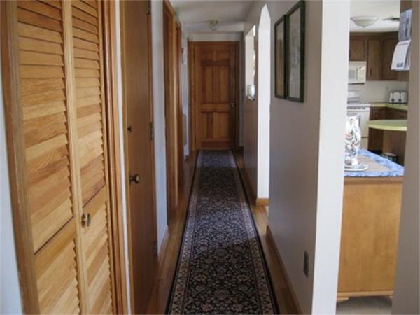 327 Mayfair Road Yarmouth, MA 02675 - Photo 14 of 29 a view of a hallway with wooden floor and a bathroom