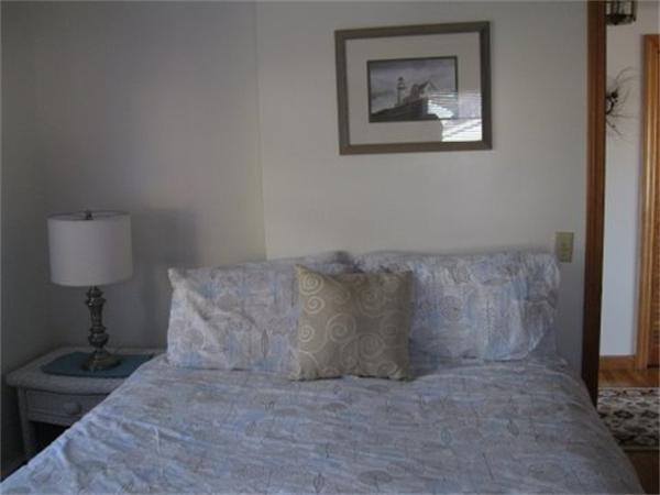 327 Mayfair Road Yarmouth, MA 02675 - Photo 17 of 29 a bed sitting in a bedroom with a lamp