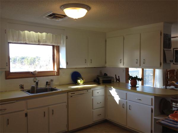 327 Mayfair Road Yarmouth, MA 02675 - Photo 23 of 29 a kitchen with stainless steel appliances a sink a stove a microwave a sink and white cabinets