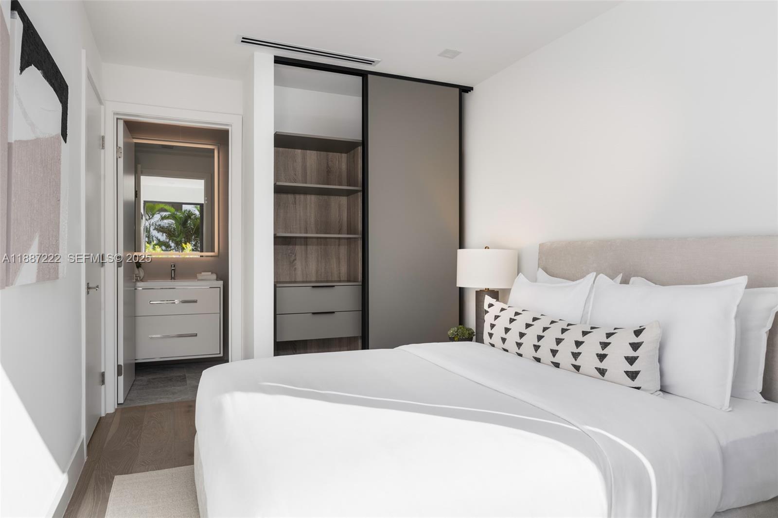 202 Sunrise Drive, Unit 202C Key Biscayne, FL 33149 - Photo 16 of 32 a bedroom with a bed and a cabinets